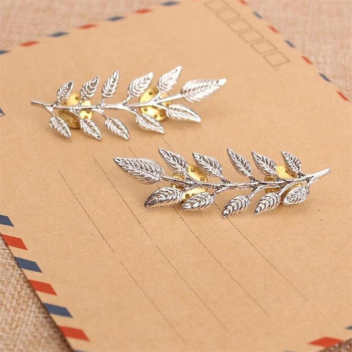Close-up of gold plating and feather details on elegant leaf brooch pin