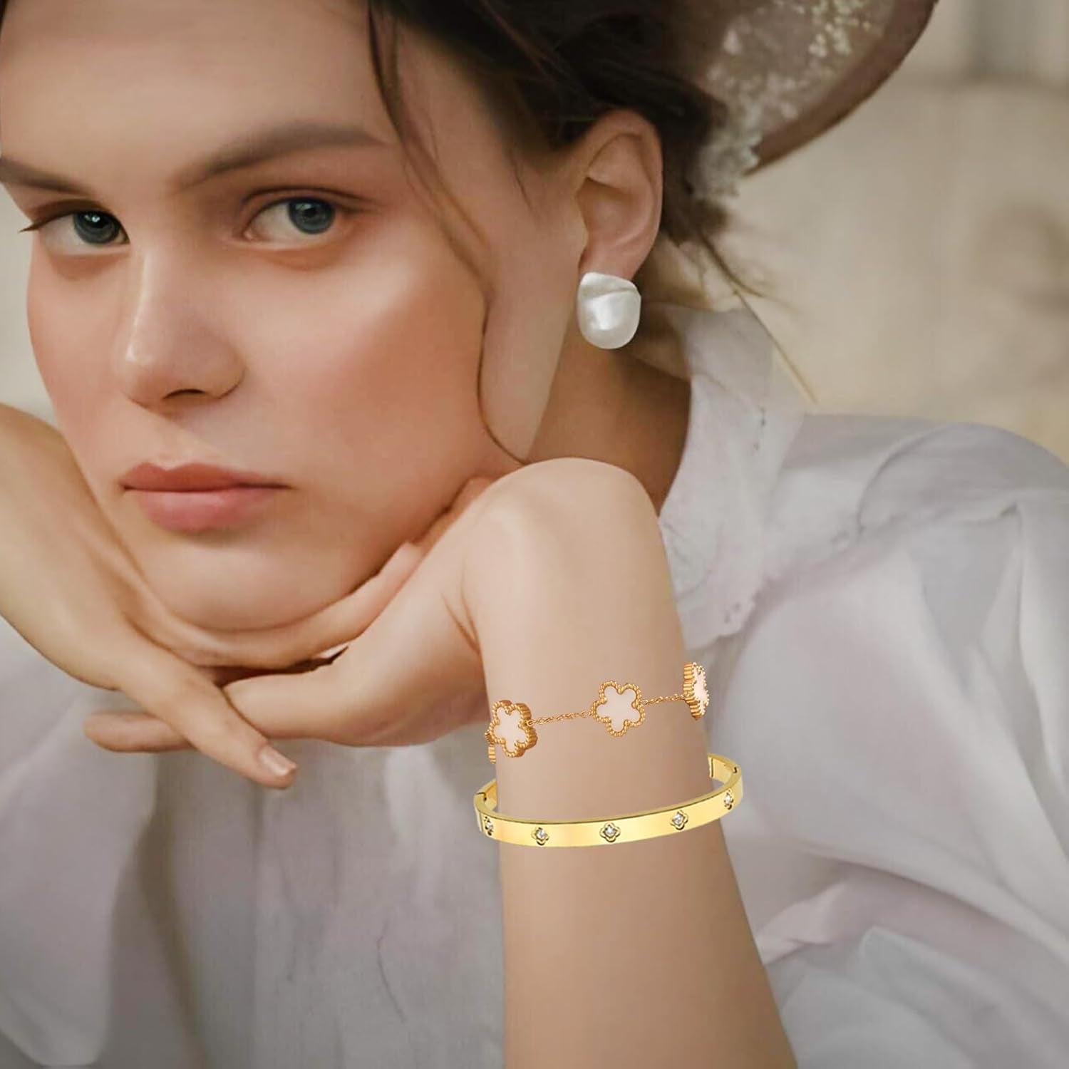 Close-up of love and clover charms on gold bracelets