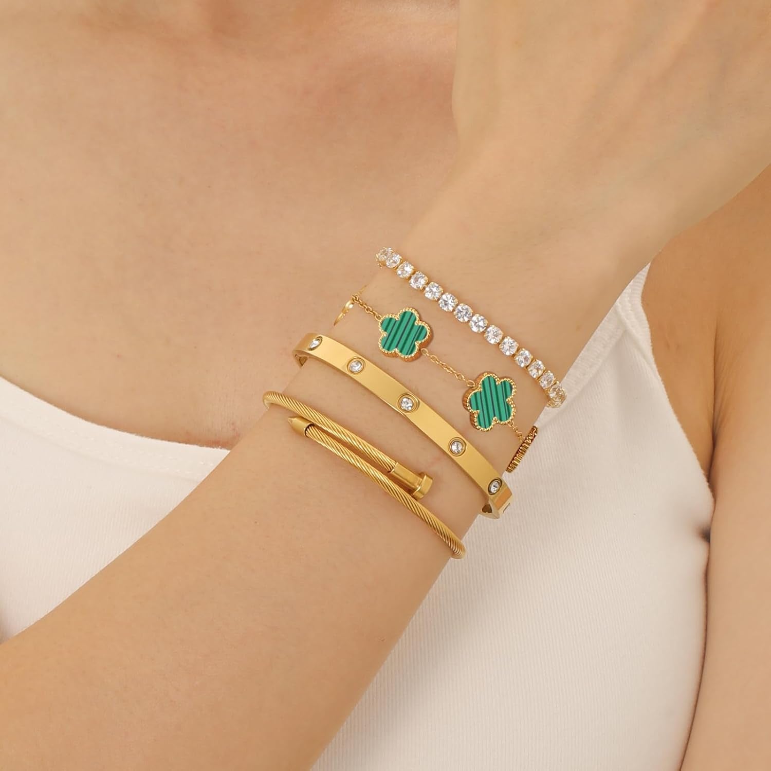 Gold clover nail love bangle bracelet stacked on wrist