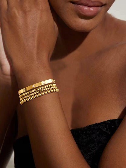 Stretch beaded bracelet stack in 14K gold tone showing cubic zirconia sparkle