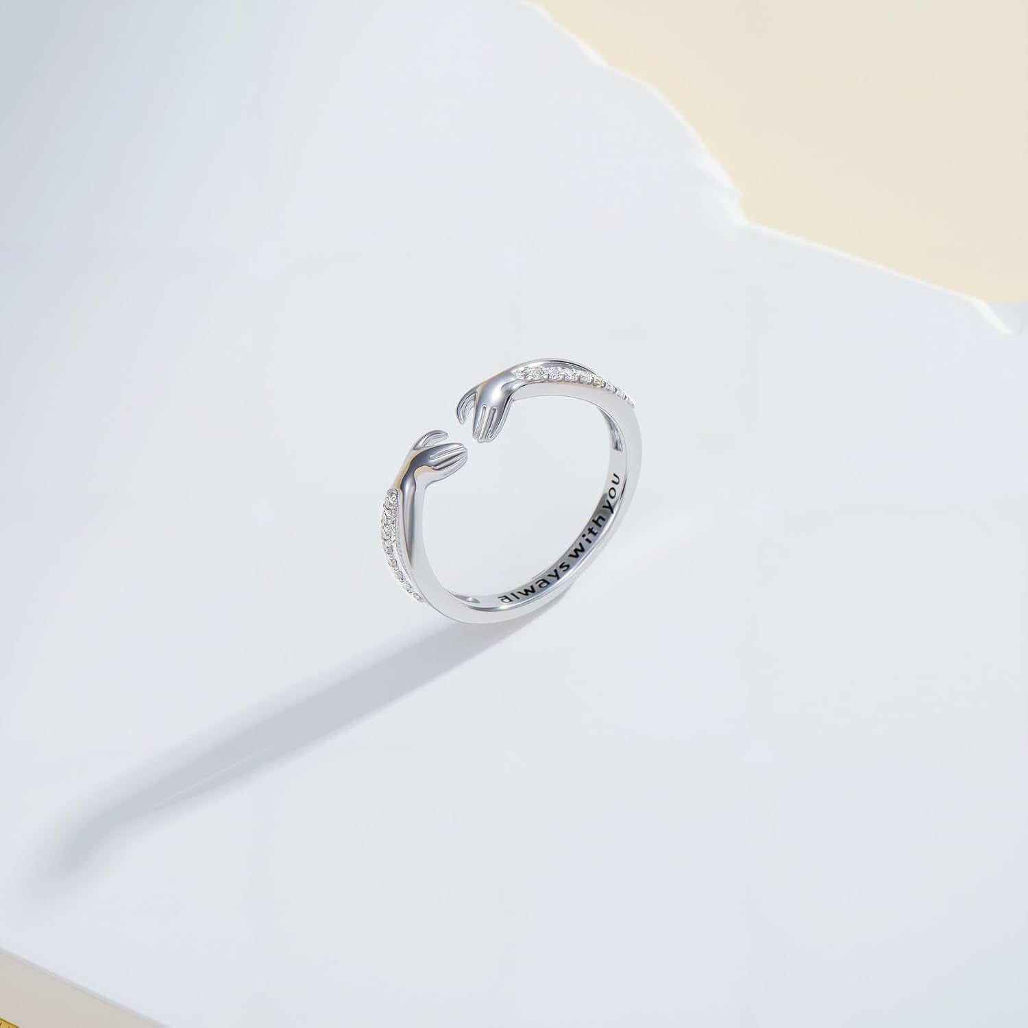Woman wearing open diamond hug ring on her hand