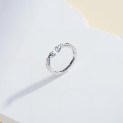 Woman wearing open diamond hug ring on her hand