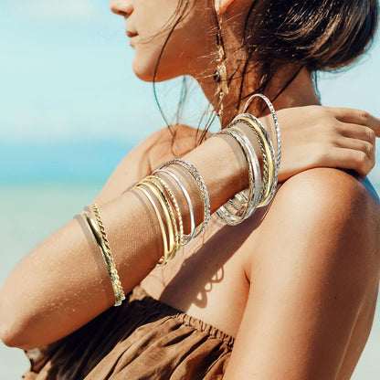 Stacked arrangement of vintage Indian bracelets from sixteen-piece set