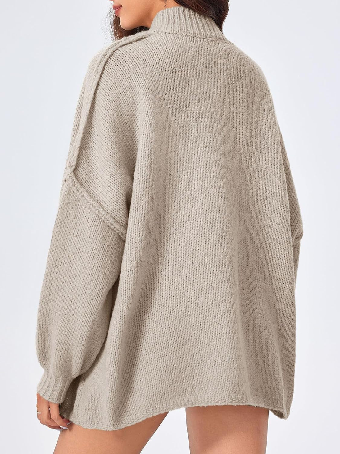Woman styling oversized chunky knit cardigan casually