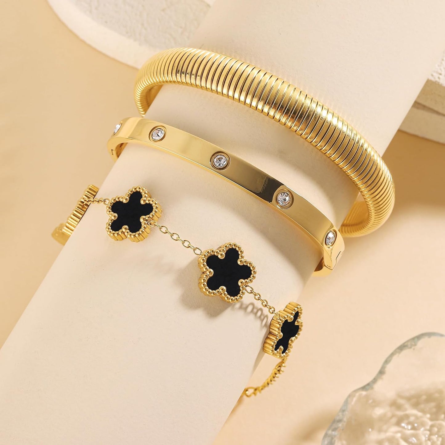 Trendy stackable gold bangles with clover charms
