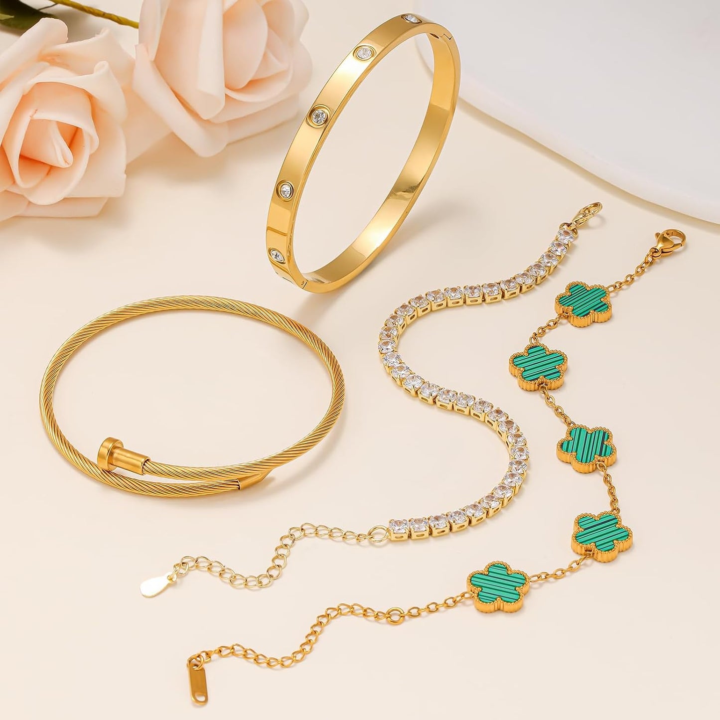 Gold tennis bracelet with nail and clover elements