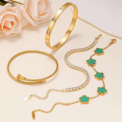 Gold tennis bracelet with nail and clover elements
