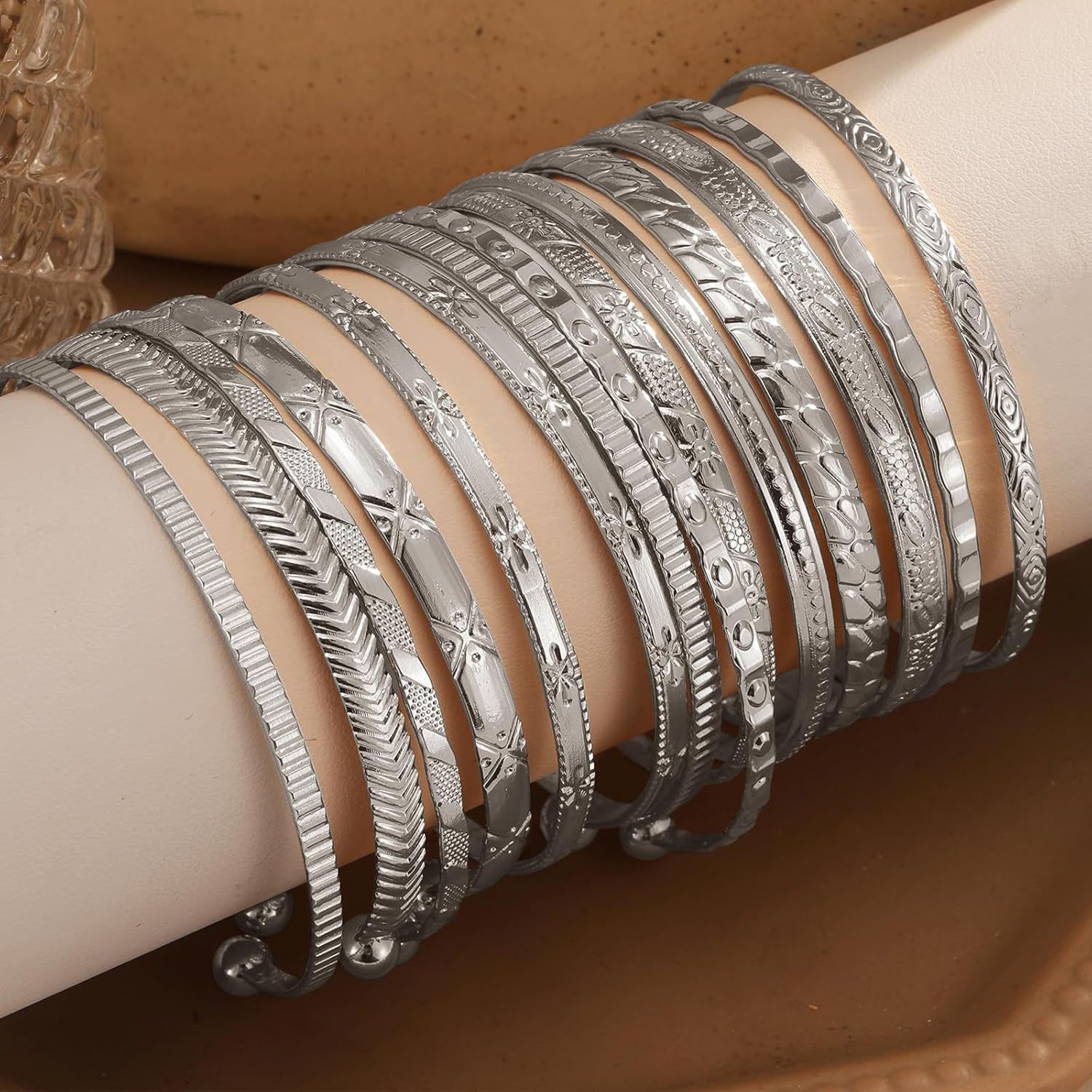 Side profile of non-tarnish gold charm bracelets on womans arm
