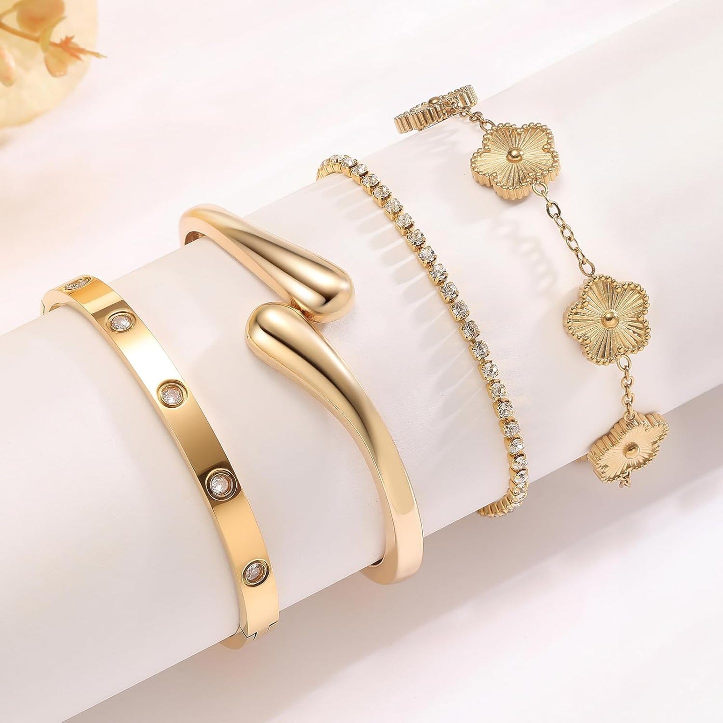 Woman wearing PDWZNBA gold plated stackable bracelets together