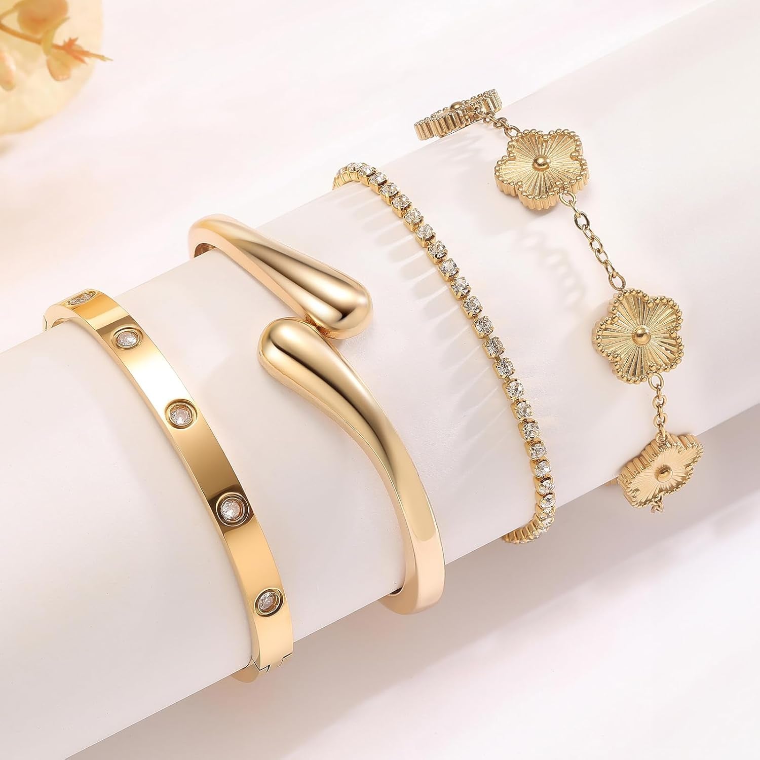 Woman wearing PDWZNBA gold plated stackable bracelets together