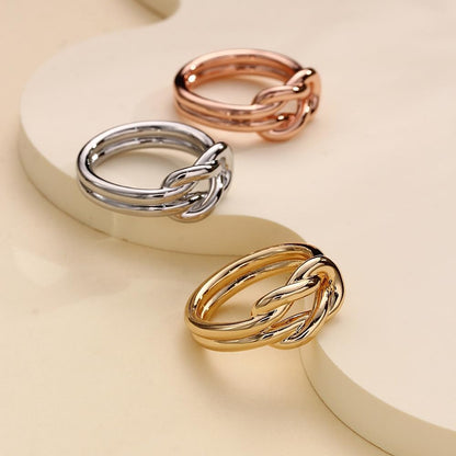 Dainty infinity knot brooch in gold tone finish