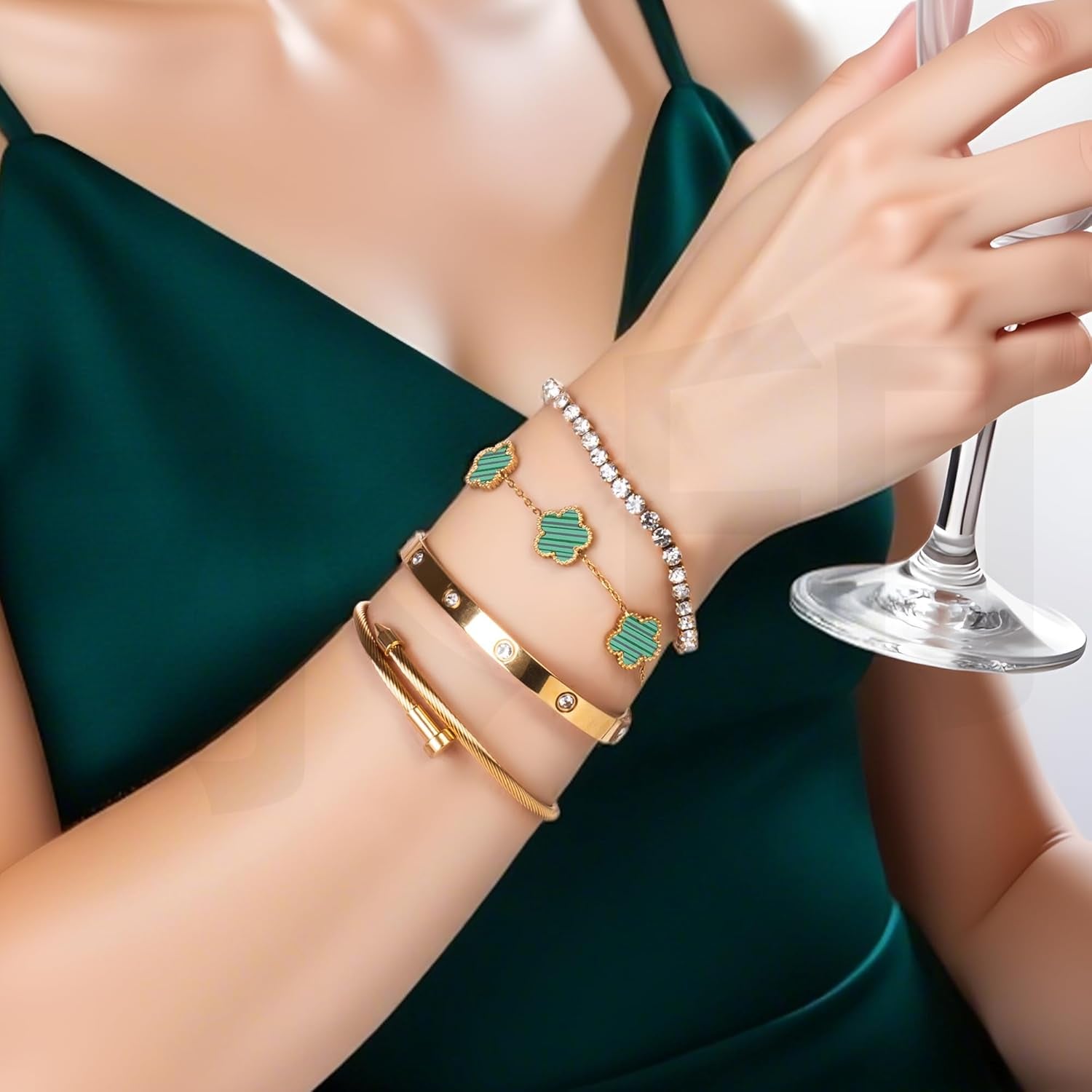 Gold clover nail bracelet stacked on woman's wrist