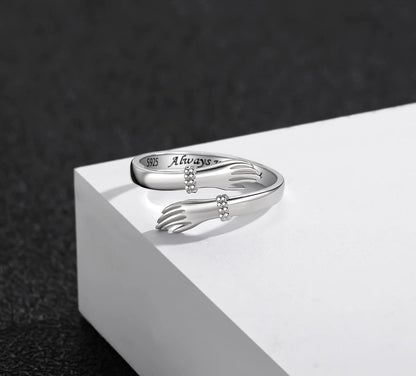 Sterling silver hand embrace ring side profile view