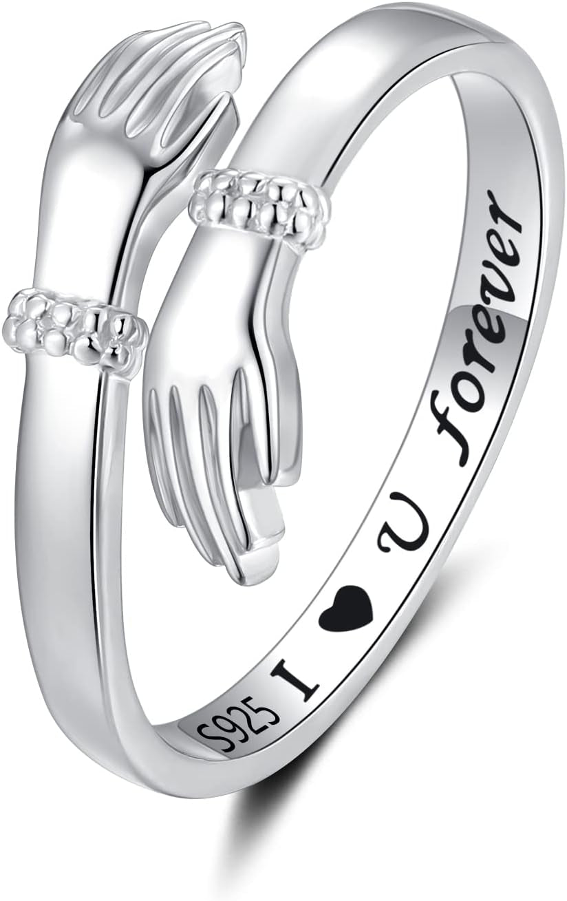 Woman displaying sterling silver hand hug ring on finger