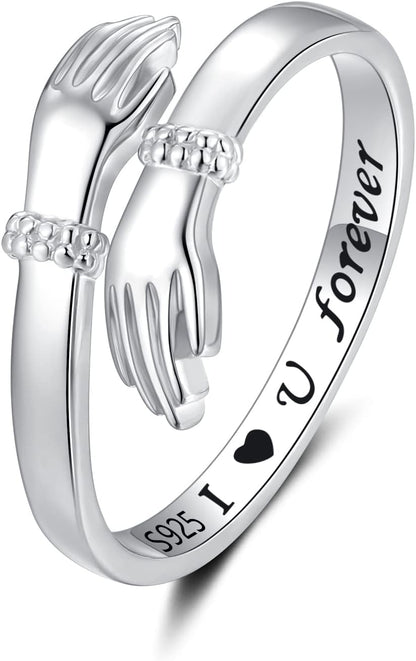 Woman displaying sterling silver hand hug ring on finger