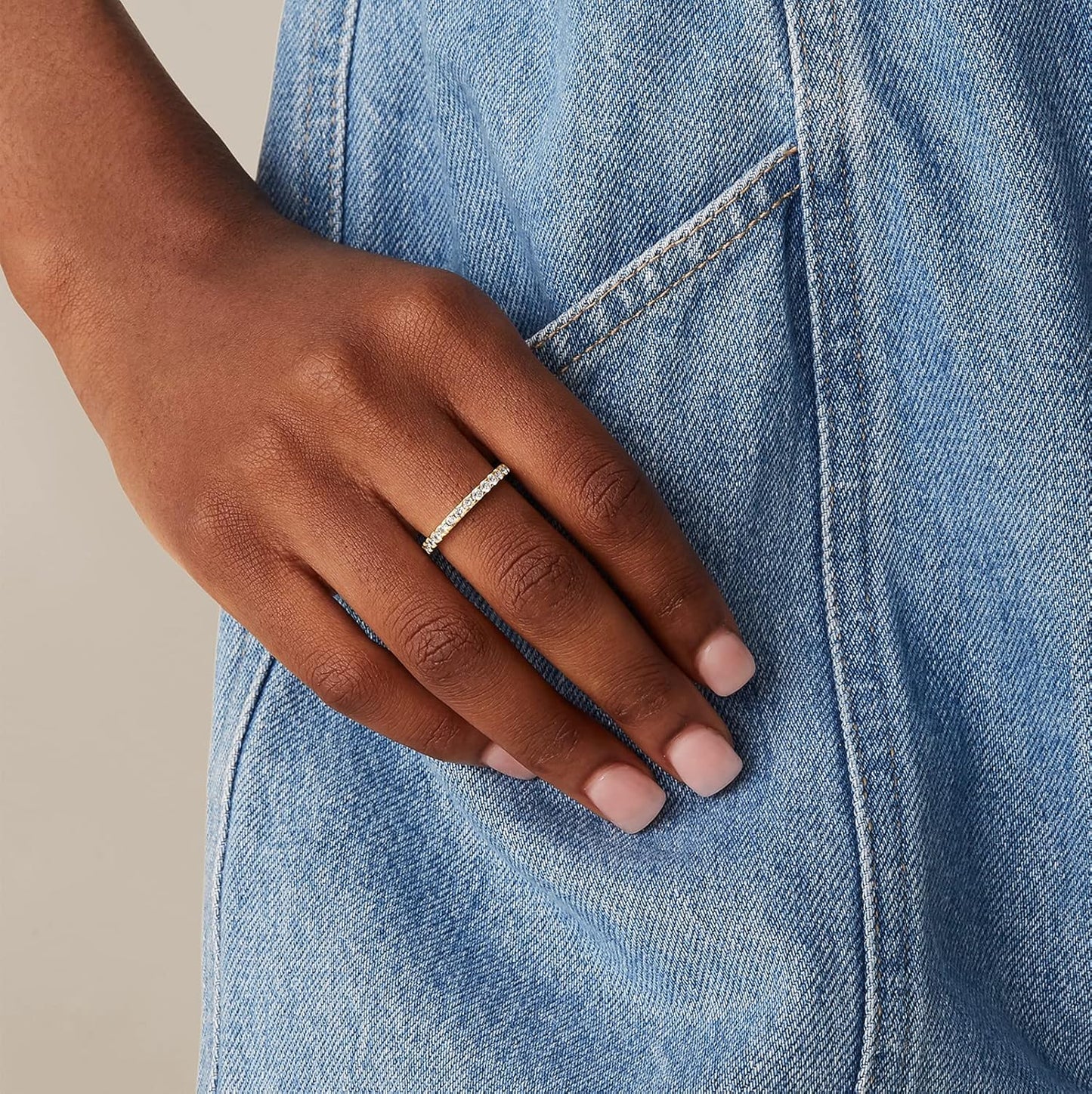 14K gold plated eternity rings stacked together on finger model