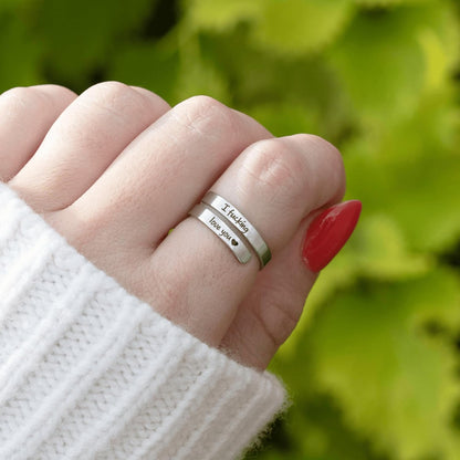 Promise ring worn on woman's finger showing adjustable fit