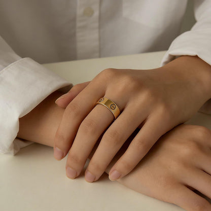 Close-up of polished gold love ring with distinctive decorative details