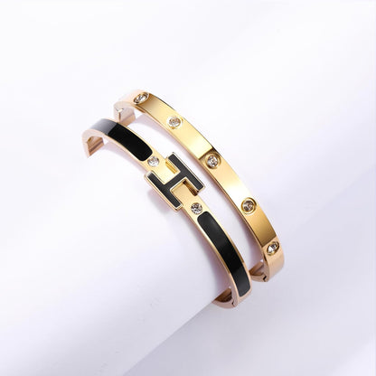 Stackable gold plated bracelets showing kindness love design