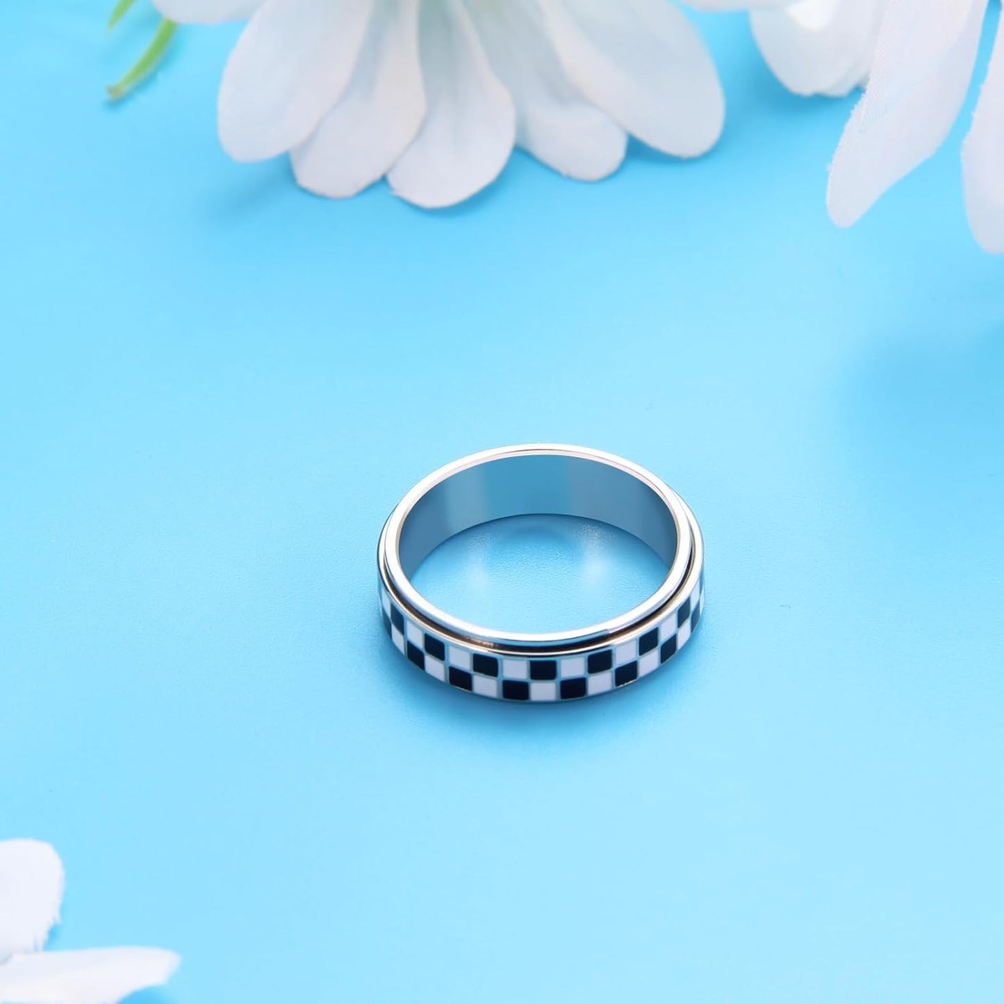 Close-up of gold plated stainless steel checkered spinner ring
