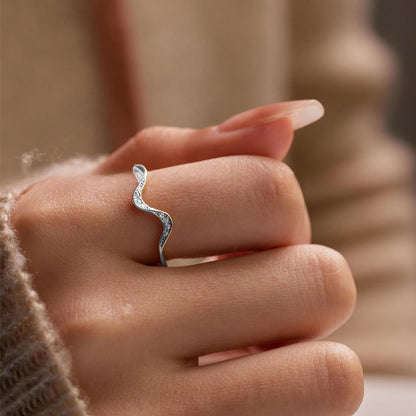 Ocean wave ring displayed on silver jewelry stand