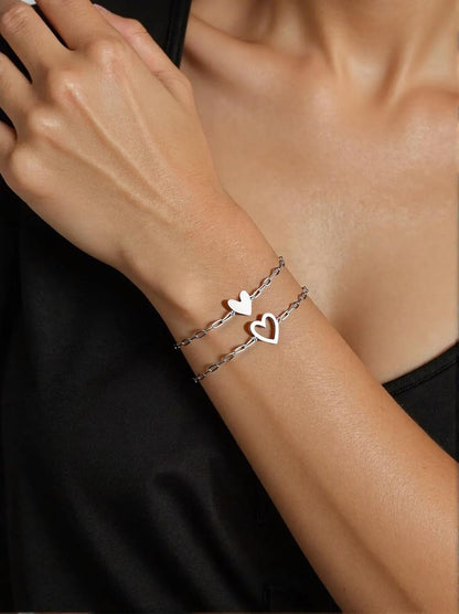 Close-up of gold heart charm on friendship bracelet