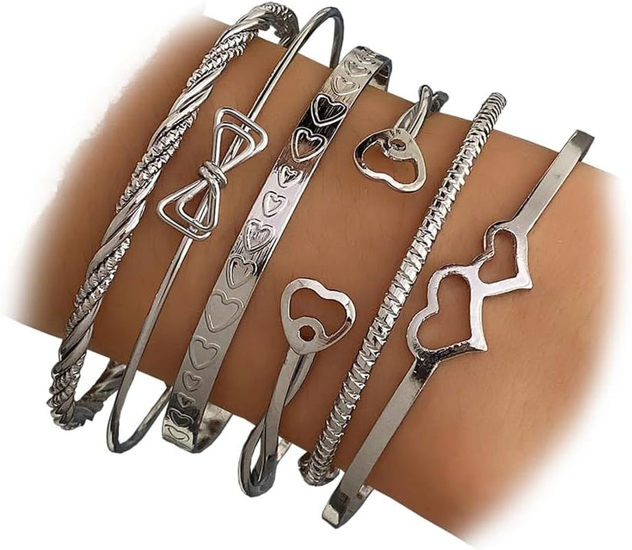 Woman modeling trendy gold layered stackable bangles jewelry