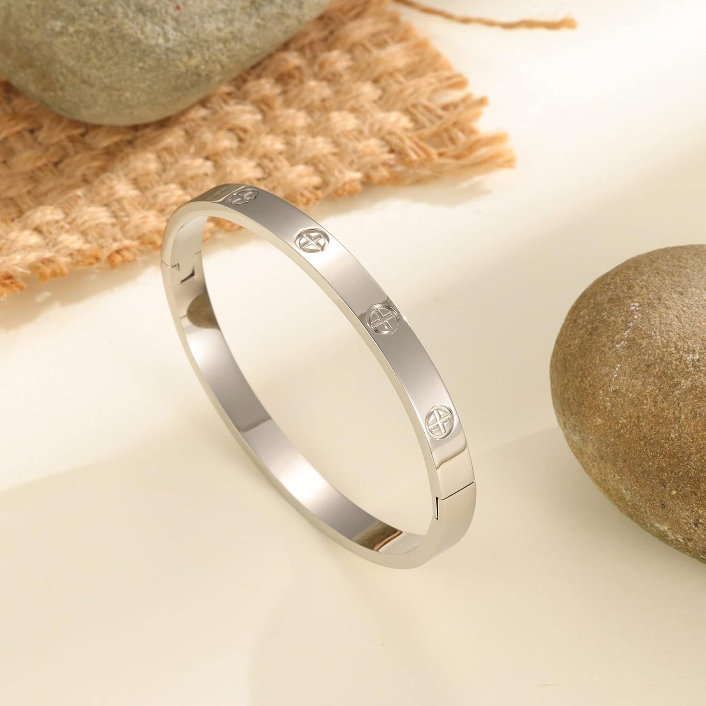 Gold plated love cuff bracelet worn on wrist demonstrating elegant fit