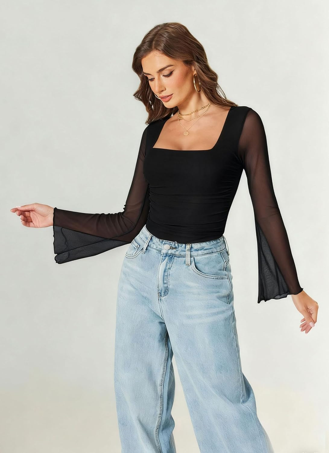 Woman wearing long sleeve mesh bodysuit going out top