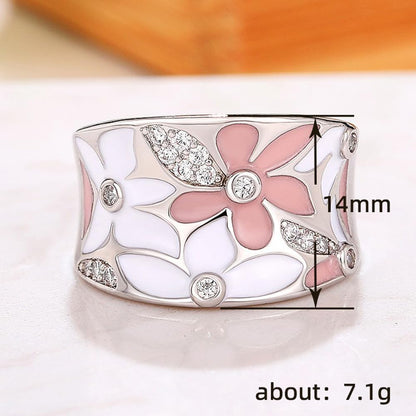 Woman wearing gold plated flower statement ring on hand