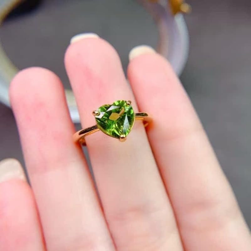 Side profile of natural peridot ring with detailed silverwork