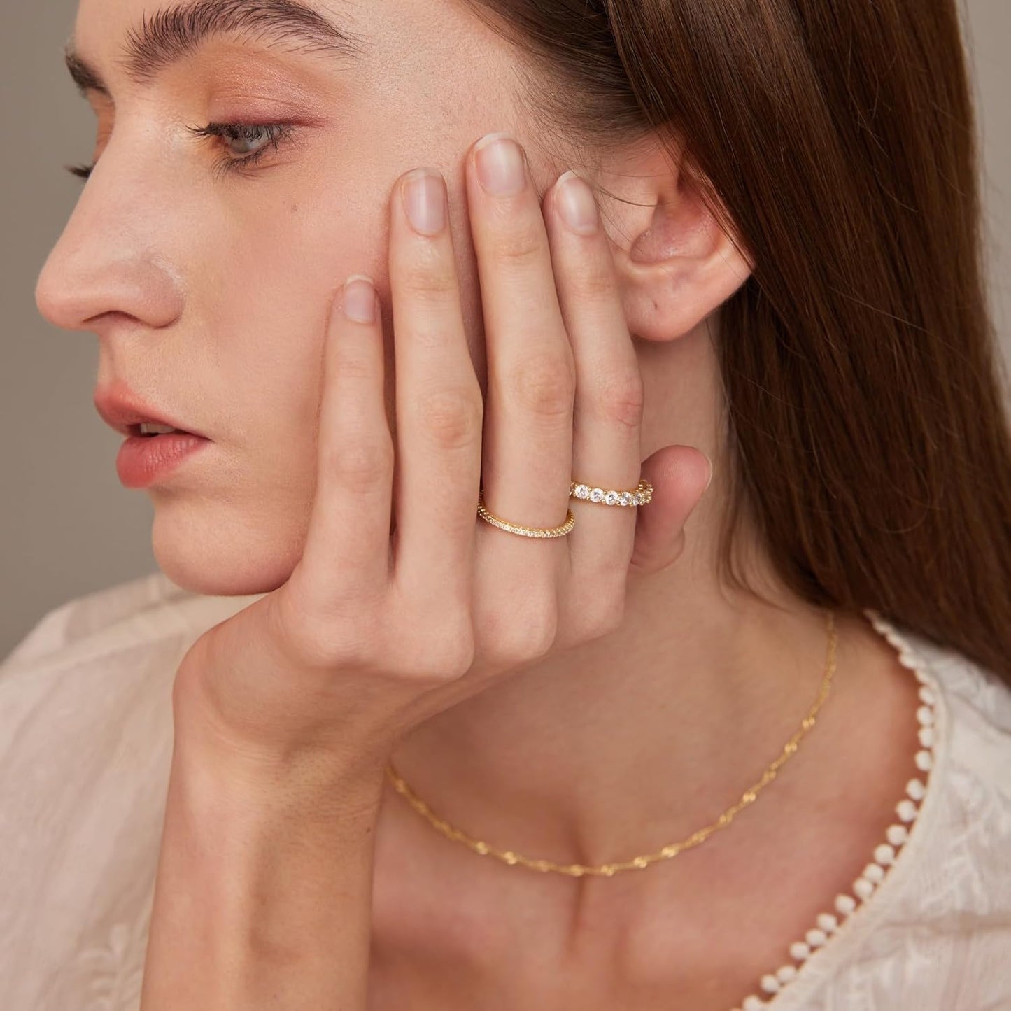 Woman wearing stacked 14K gold cubic zirconia rings