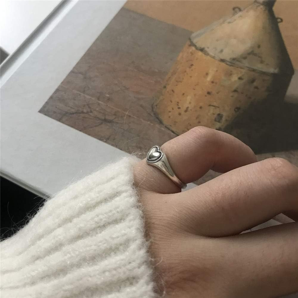 Close-up detail of polished vintage heart silver ring design