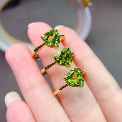 Top view of heart-shaped peridot stone in silver mounting