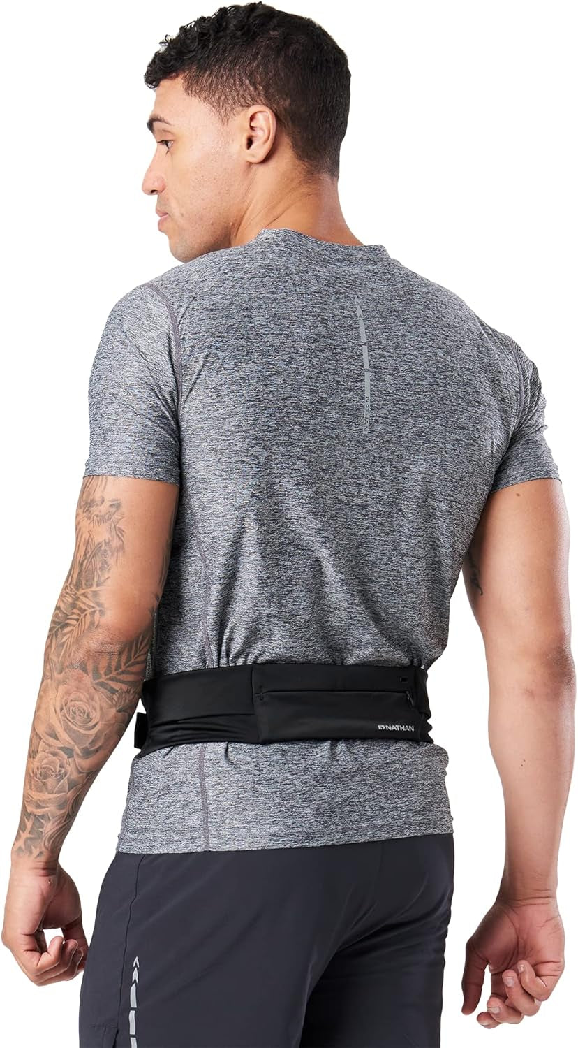 Woman wearing Nathan Zipster belt while trail running
