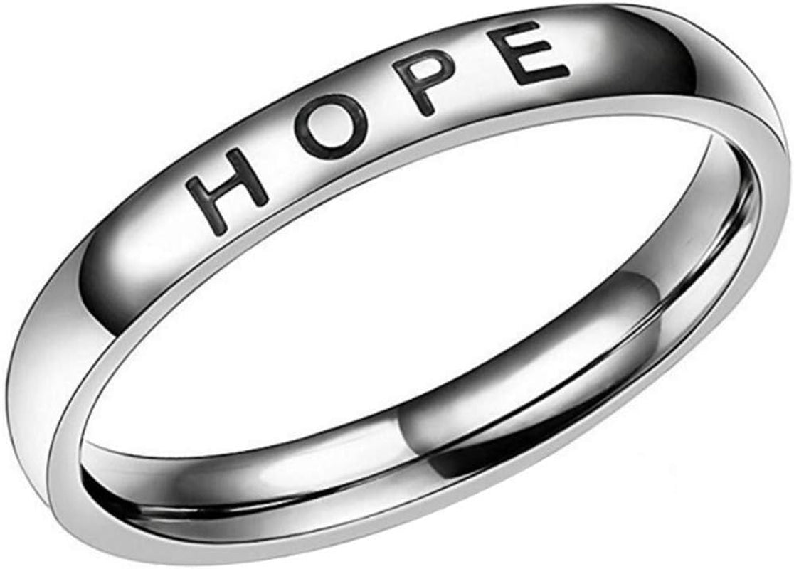 Mantra wedding band ring worn on woman's hand with faith and hope message