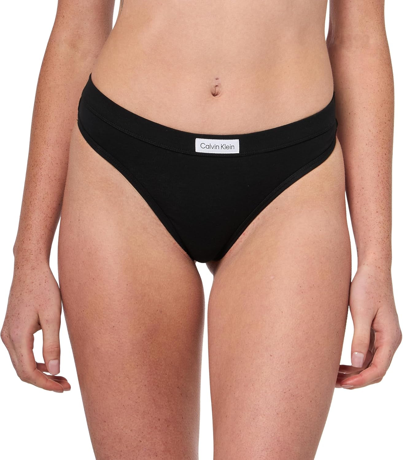 Close-up of Calvin Klein logo patch on flexible thong waistband