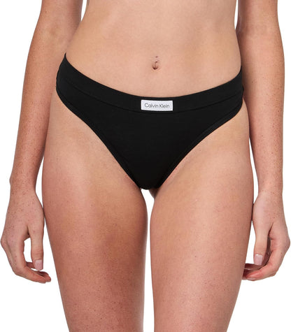Close-up of Calvin Klein logo patch on flexible thong waistband