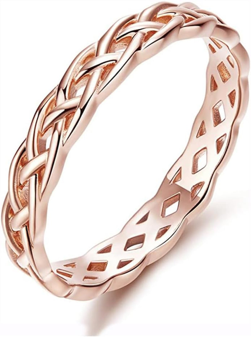 Multiple stacked Celtic knot rings layered together on hand