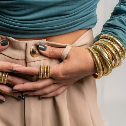 Overhead view of three tarnish-free gold bangles together