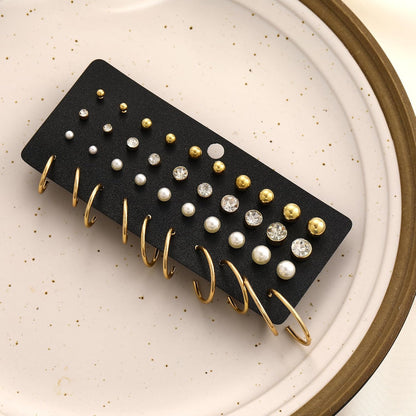 Fifteen gold stud earrings in assorted shapes and sizes