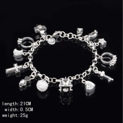 Full S925 silver thirteen piece charm bracelet laid flat showing all hanging elements