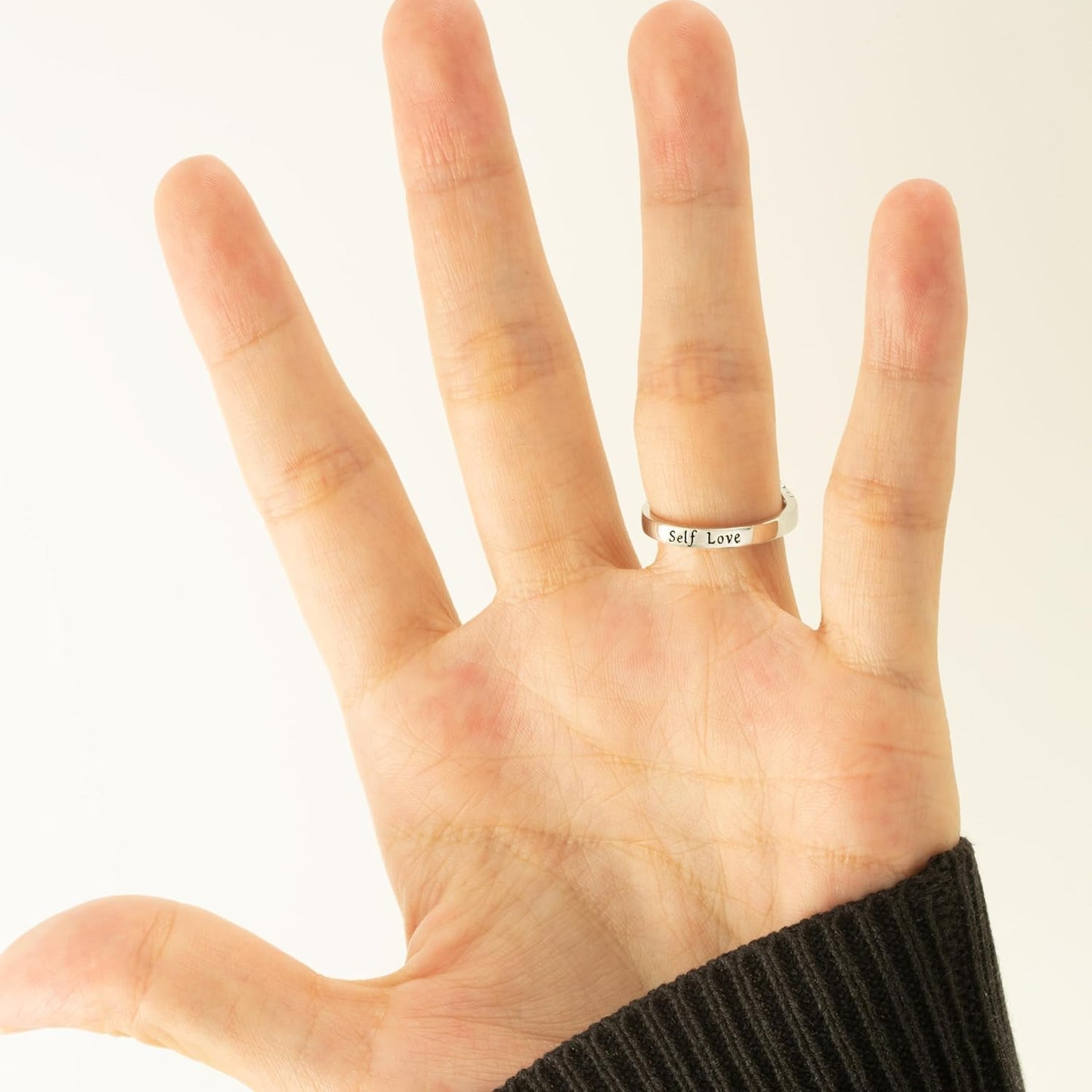 Blue wave ring with empowering message on woman's finger