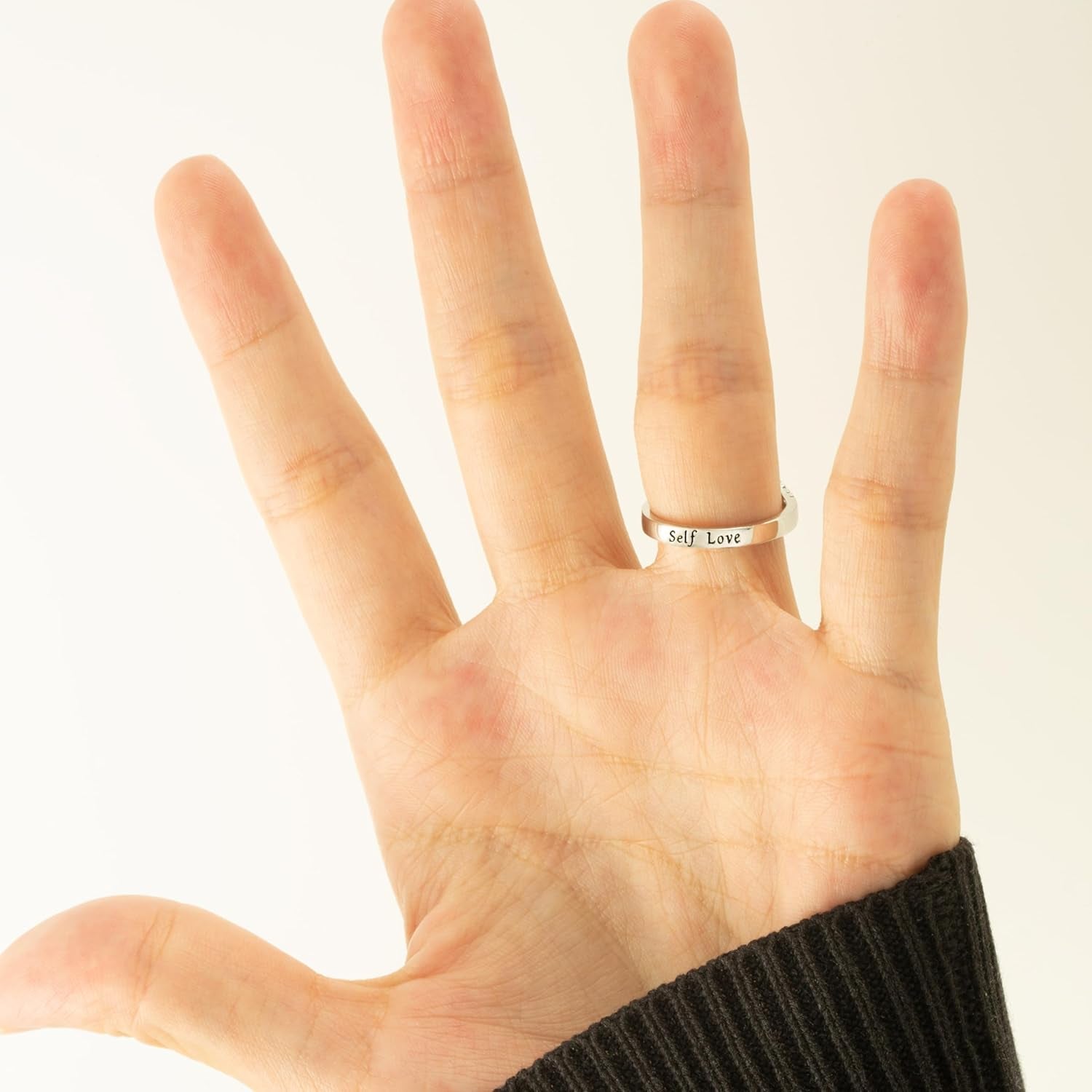 Blue wave ring with empowering message on woman's finger