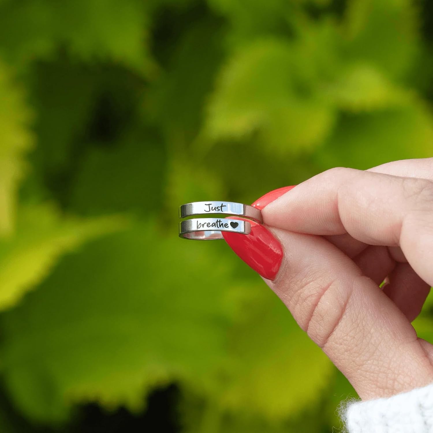 Adjustable heart ring on woman's hand displaying comfort fit