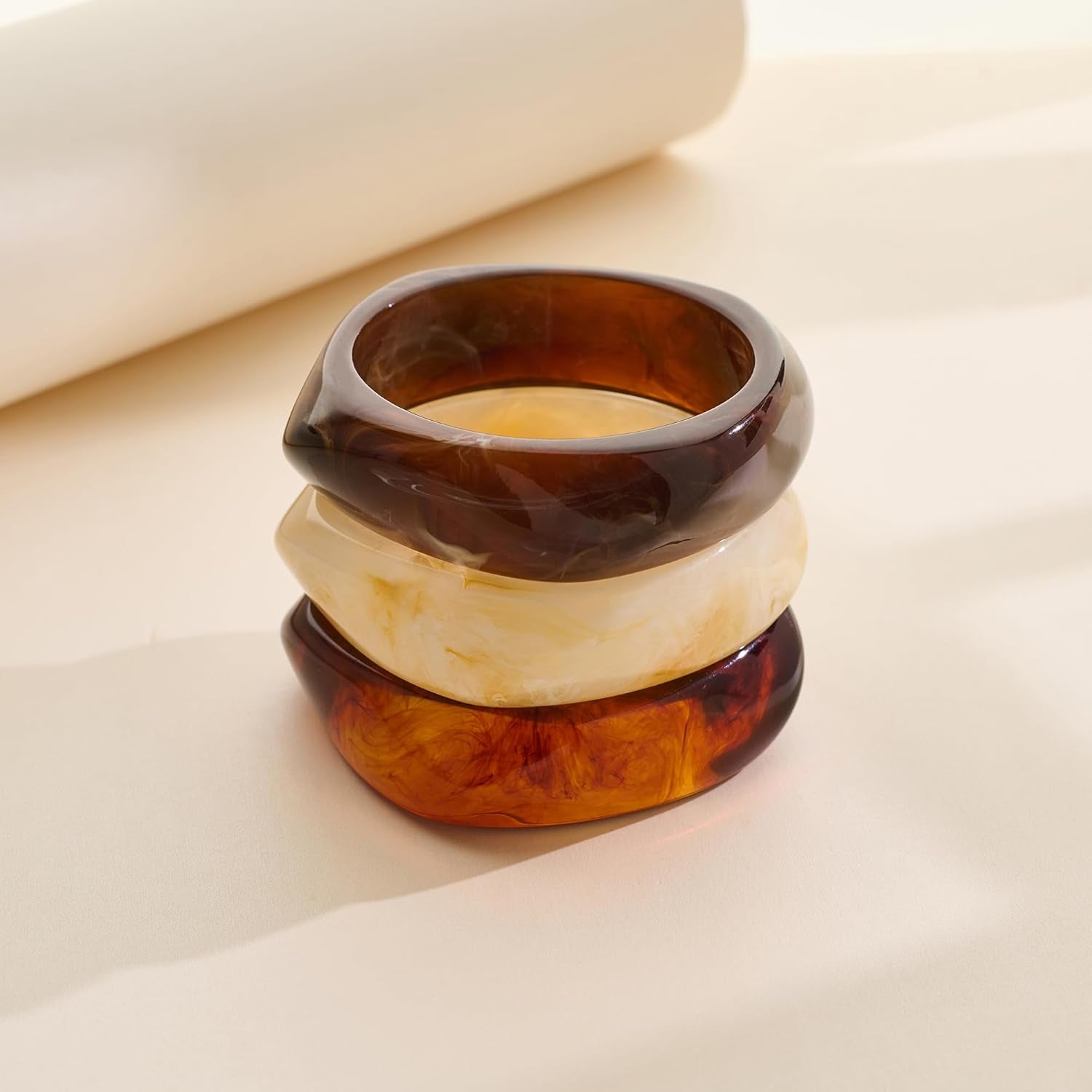 Woman wearing chunky resin statement bracelets together