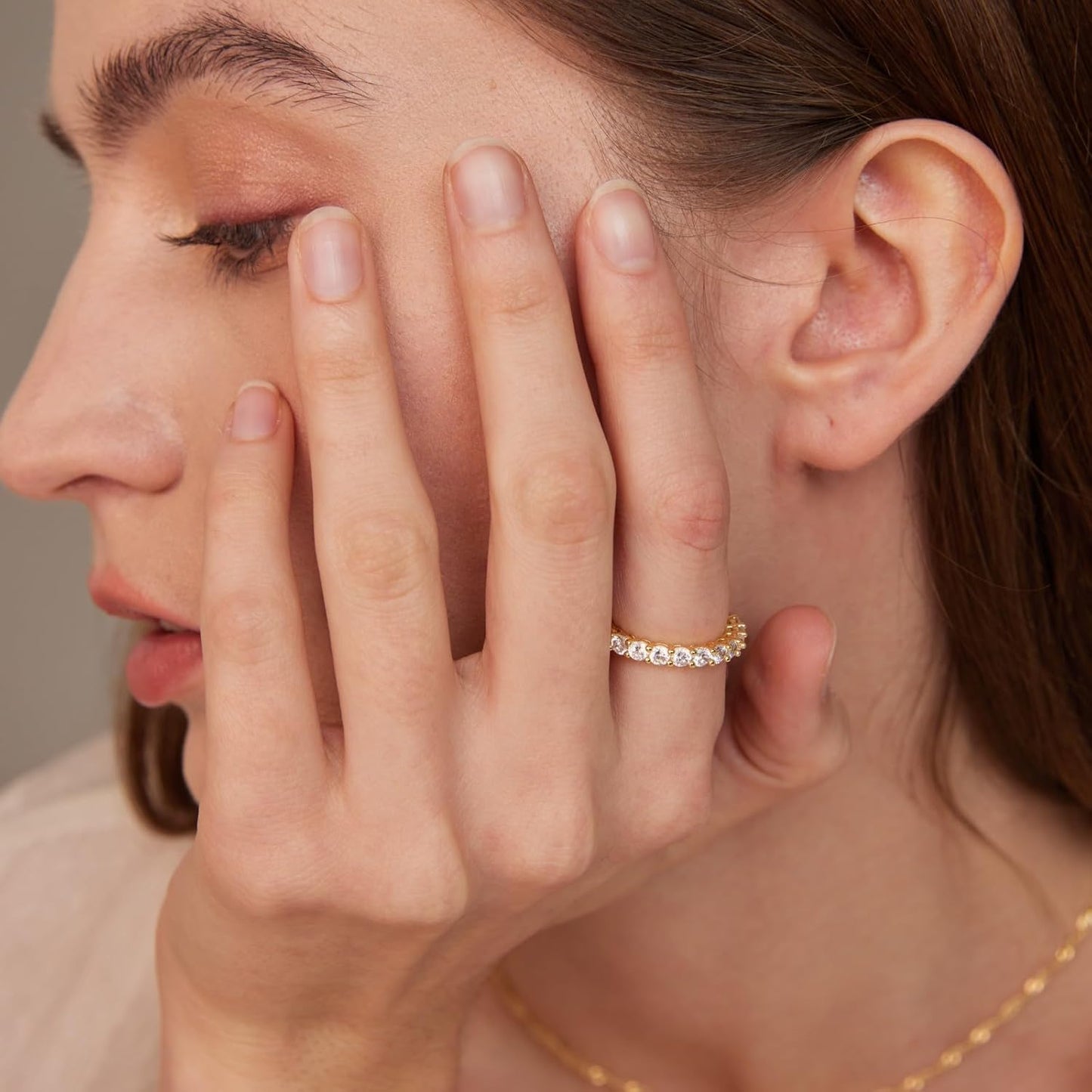Multiple stackable gold rings worn together
