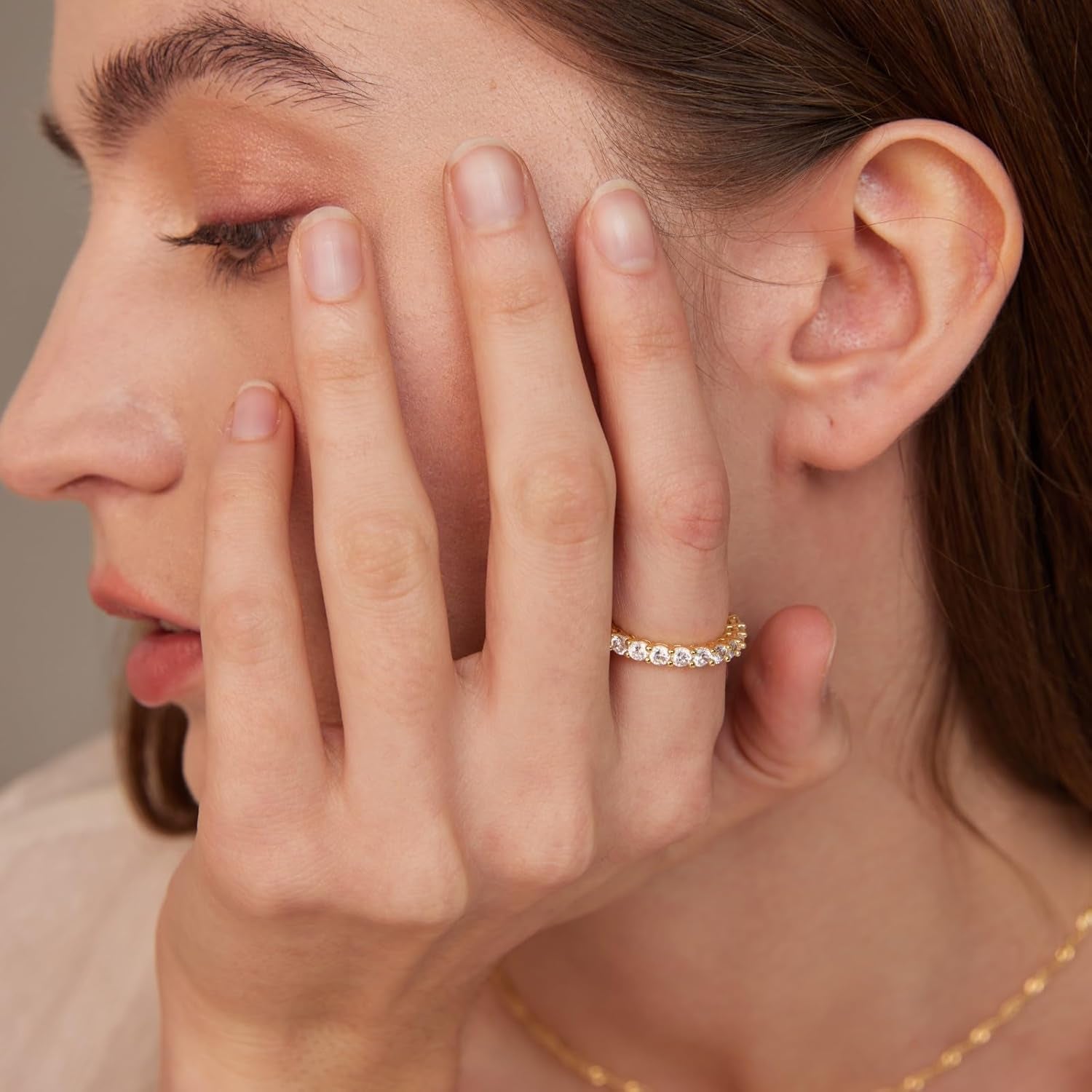 Multiple stackable gold rings worn together