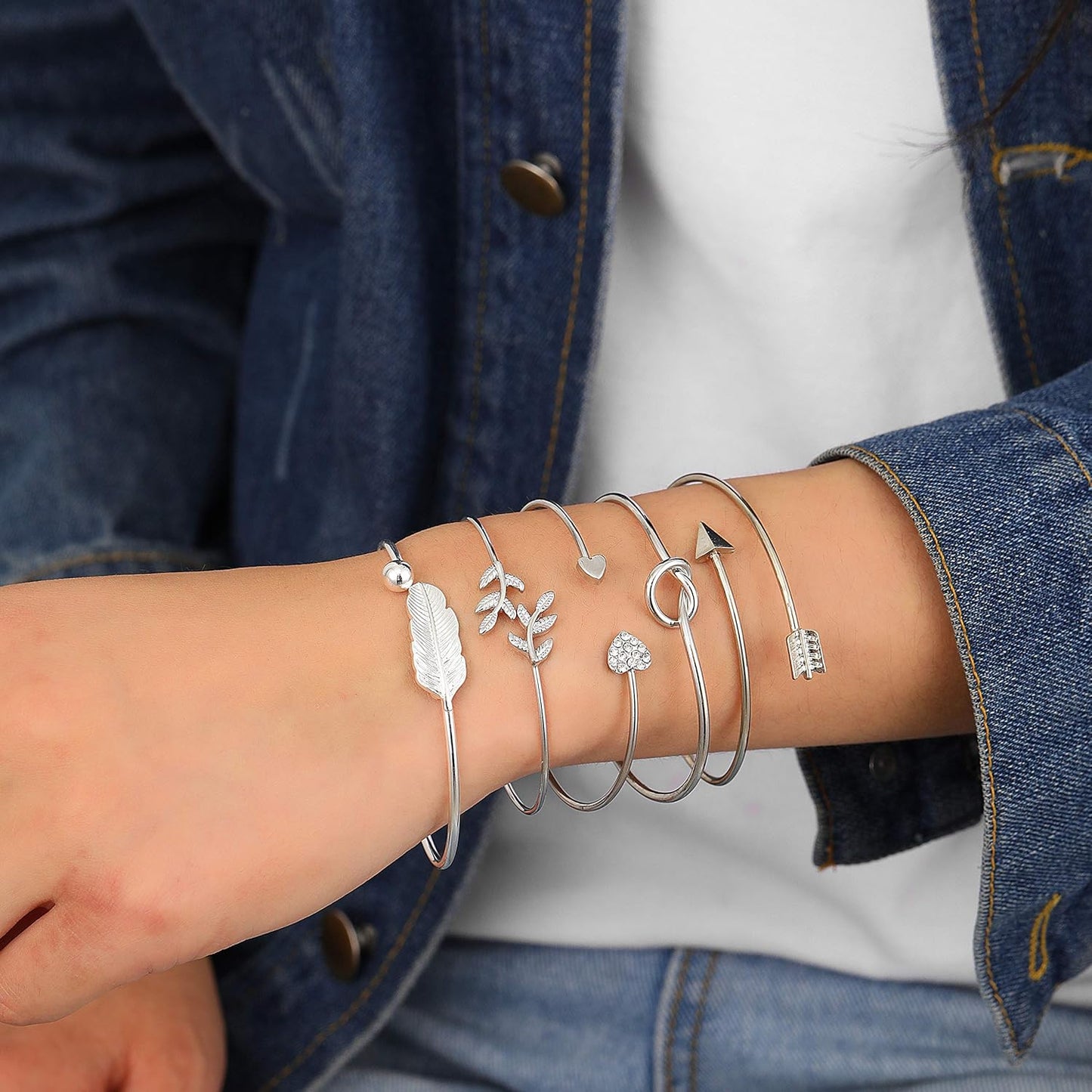 Woman wearing all five rose gold bangles stacked together