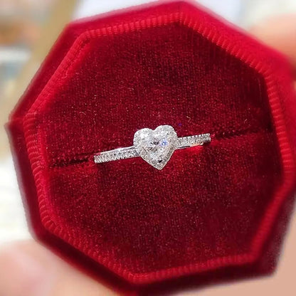 Heart love ring worn on woman's finger showing elegant design